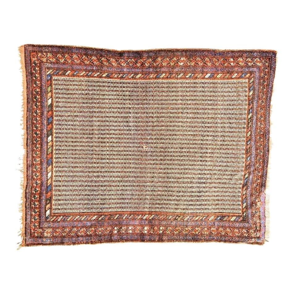 5'1" x 6'7" Quasqai Wool Tribal Hand Knotted Rug Antique: 5'1" x 6'7" Quasqai Wool Tribal Hand Knotted Rug Antique This antique Quasqai hand-knotted rug features a traditional tribal design with natural colors and a soft texture. Crafted from wool, it showca