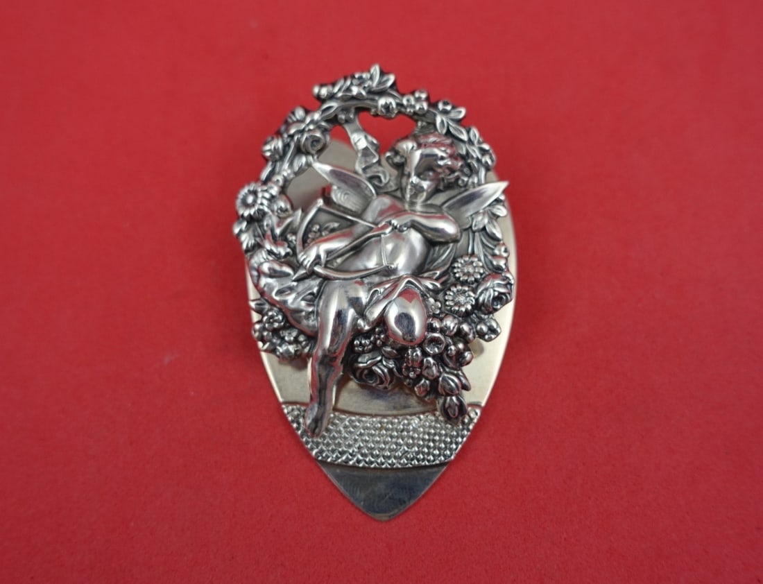 Sterling Silver Figural Paper Clip Cupid Pattern by Shiebler 2 x 3 Inches: Sterling Silver Figural Paper Clip Cupid Pattern by Shiebler 2 x 3 Inches This sterling silver paper clip by Shiebler features a figural Cupid design with a bow, arrow, flowers, and heart motifs. The 