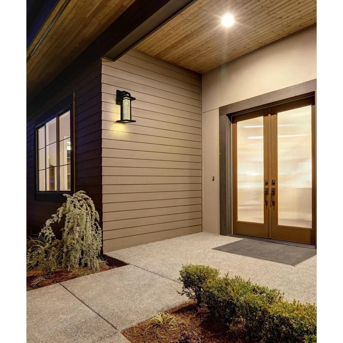 Uriah Black LED Wall Light Seedy Glass Outdoor Sconce: Uriah Black LED Wall Light Seedy Glass Outdoor Sconce This outdoor wall sconce features a sleek black metal frame paired with a clear seedy glass cylinder, offering a sophisticated and modern look for