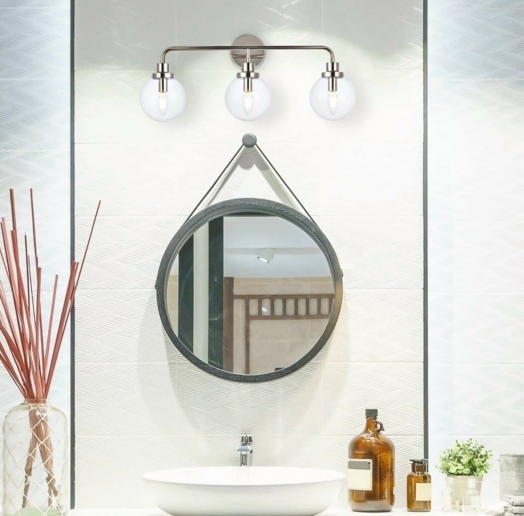 Hanson 3 Light Polished Nickel Glass Wall Sconce 27.6 inch: Hanson 3 Light Polished Nickel Glass Wall Sconce 27.6 inch This modern wall sconce features a polished nickel finish with three clear glass shades, offering both upward and downward lighting. Designed