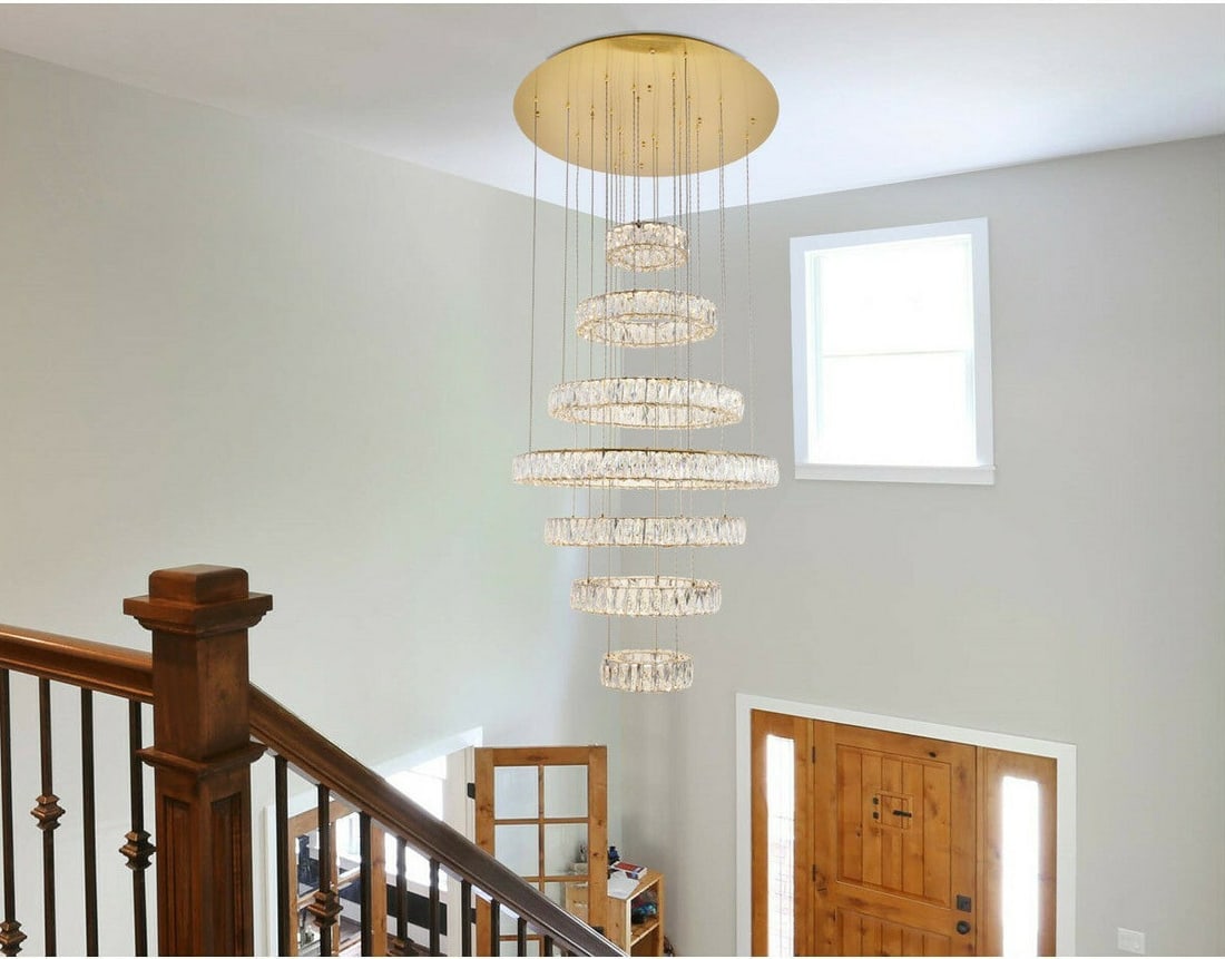 Monroe Gold Crystal LED Chandelier 34 inch Height Adjustable: Monroe Gold Crystal LED Chandelier 34 inch Height Adjustable This large modern chandelier features a striking design with seven tiers of minimal stainless steel rings in a gold finish, adorned with ro