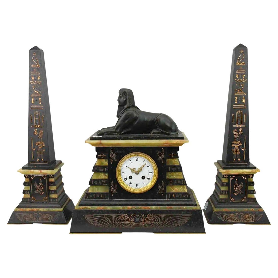 French Empire Egyptian Revival Bronze Mantel Clock with Matching Obelisks Set: French Empire Egyptian Revival Bronze Mantel Clock with Matching Obelisks Set This antique French Empire Egyptian Revival garniture set, dating to the 19th century, features a mantel clock and a pair 