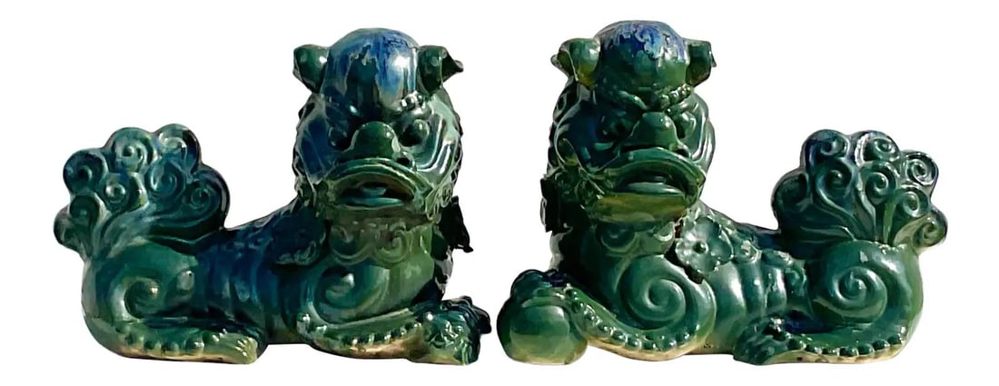 Pair of Vintage Glazed Ceramic Foo Dogs in Dark Green: Pair of Vintage Glazed Ceramic Foo Dogs in Dark Green This stunning pair of vintage glazed ceramic foo dogs showcases a chic deep green color accented with flashes of deep blue. Each piece features in