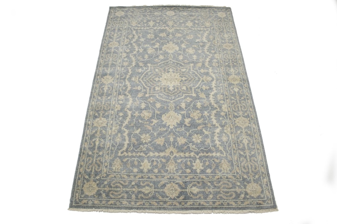 Hand-Knotted Wool Area Rug with Slate Floral Design 5x8 Feet: Hand-Knotted Wool Area Rug with Slate Floral Design 5x8 Feet This hand-knotted wool area rug features a muted slate floral pattern, blending traditional and modern design elements. Crafted in India, i