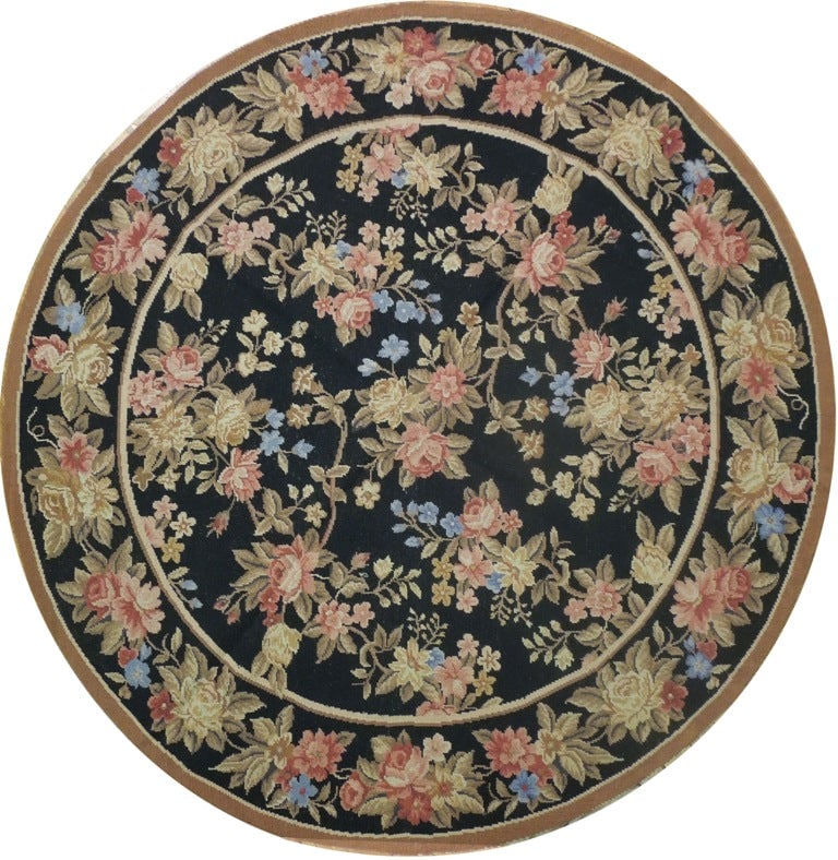 5' x 5' Black Hand-Knotted Needlepoint Round Area Rug: 5' x 5' Black Hand-Knotted Needlepoint Round Area Rug Free continental US Shipping Enhance your living space with the 5' x 5' Black Needlepoint Flat Weave Round Rug. This exquisite area rug showcases 
