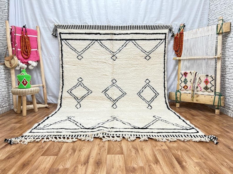 Handwoven Lovely Soft White Rug 100% Local Wool Morocco: Handwoven Lovely Soft White Rug 100% Local Wool Morocco Discover the charm of this Authentic Lovely Soft White Rug, handwoven in the Atlas Mountains by skilled Berber women weavers. Crafted using trad