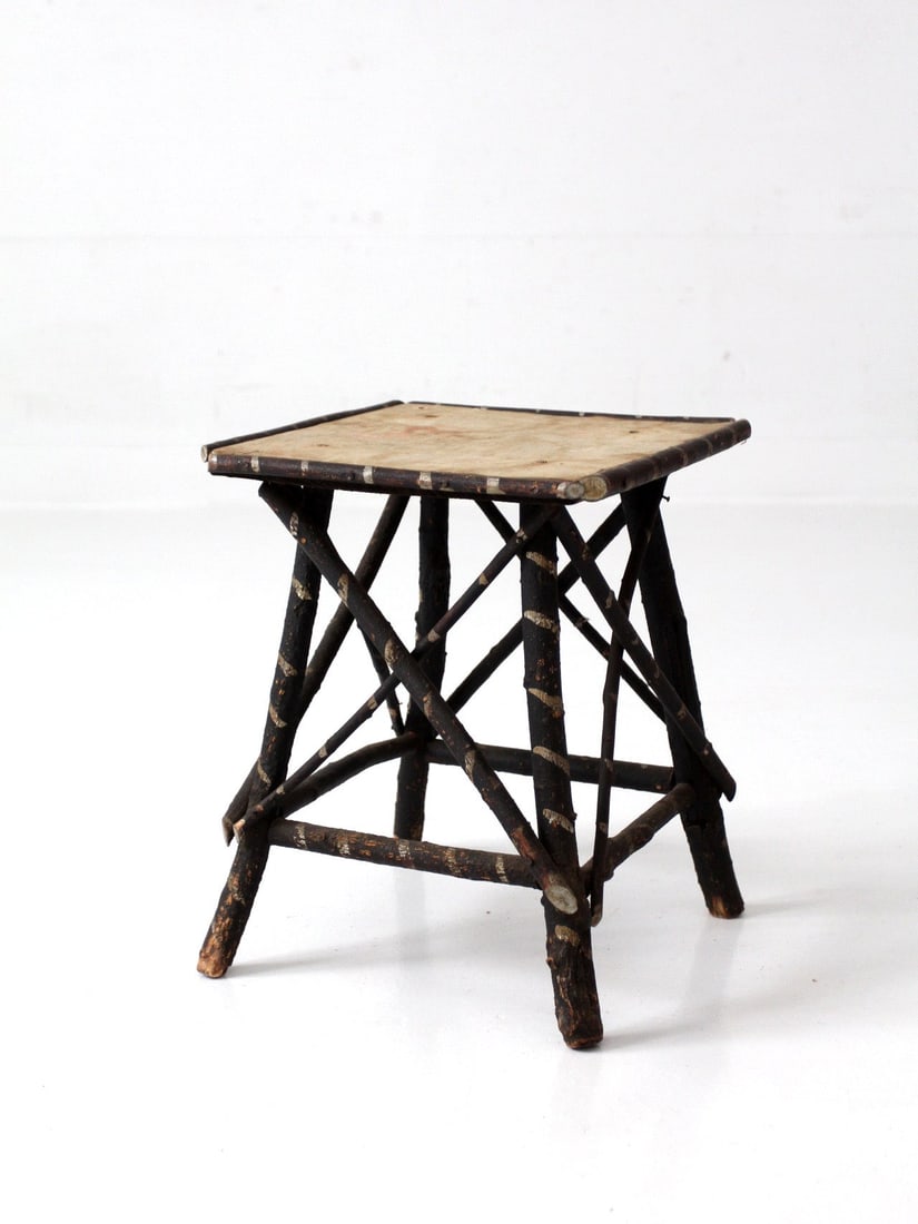 Early 20th Century Adirondack Twig Side Table Floral Cloth Top: Early 20th Century Adirondack Twig Side Table Floral Cloth Top This early 20th century Adirondack twig table features a bark-on branch construction paired with a faded floral cloth top, offering a sof