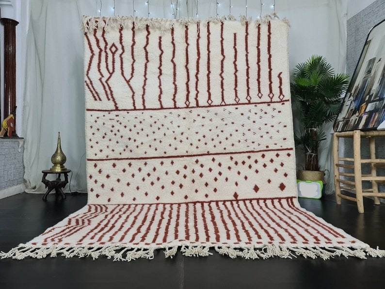Handmade Moroccan Berber Wool Rug Red Dots 9.84x6.56 Feet: Handmade Moroccan Berber Wool Rug Red Dots 9.84x6.56 Feet Experience the beauty of this stunning White Soft Handmade Moroccan Berber Wool Rug. Featuring an assorted pattern with red dots, this rug is 