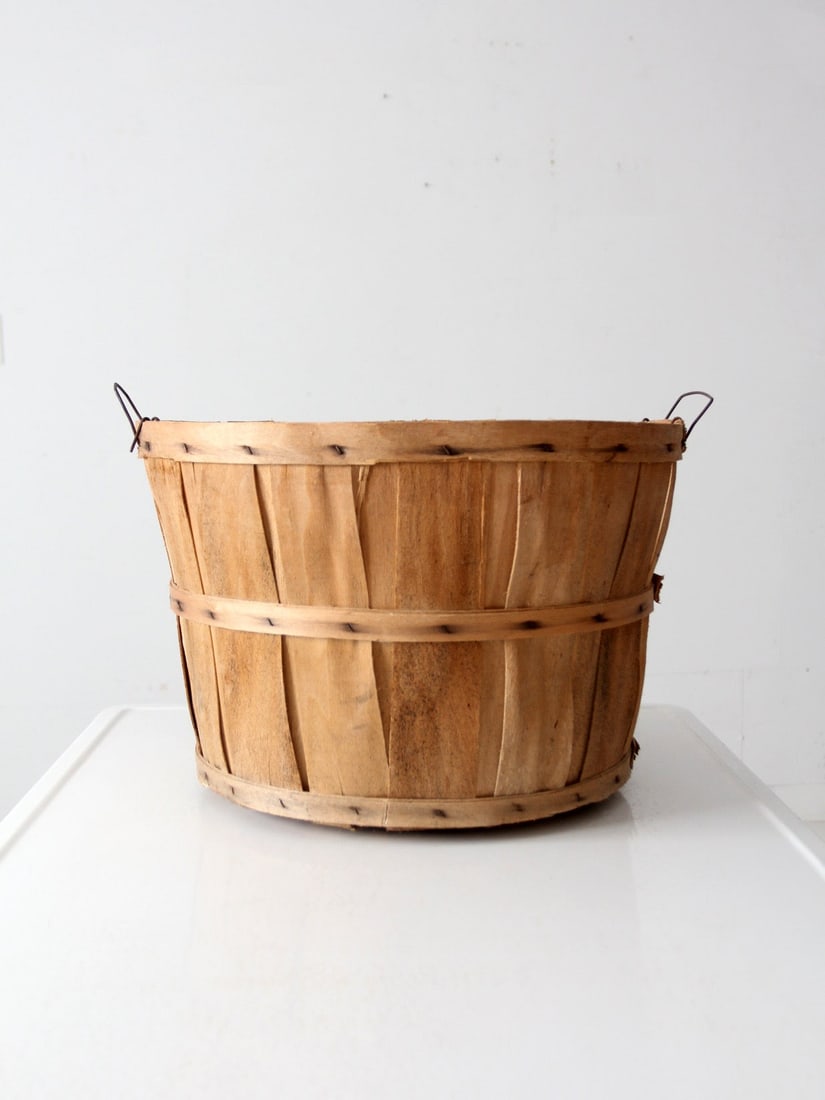 Rustic Vintage Wooden Apple Orchard Basket with Metal Handles: Rustic Vintage Wooden Apple Orchard Basket with Metal Handles This vintage apple orchard bushel basket is crafted from light wooden staves and features small metal side handles. Originally used for ha