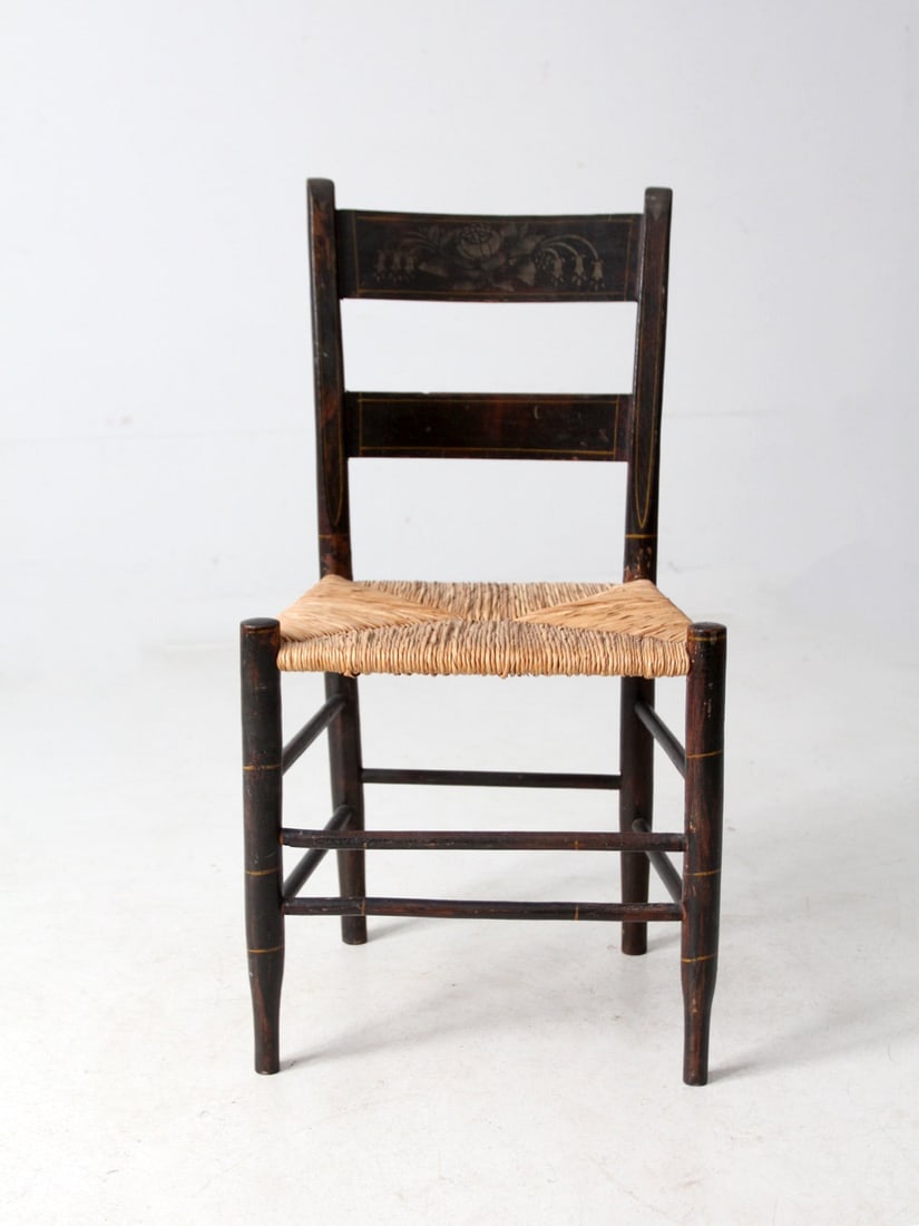 Antique Ladder Back Chair with Woven Rush Seat: Antique Ladder Back Chair with Woven Rush Seat This antique ladder back chair showcases a beautifully woven rush seat and features a charming stenciled design on the top rail, making it a lovely addit