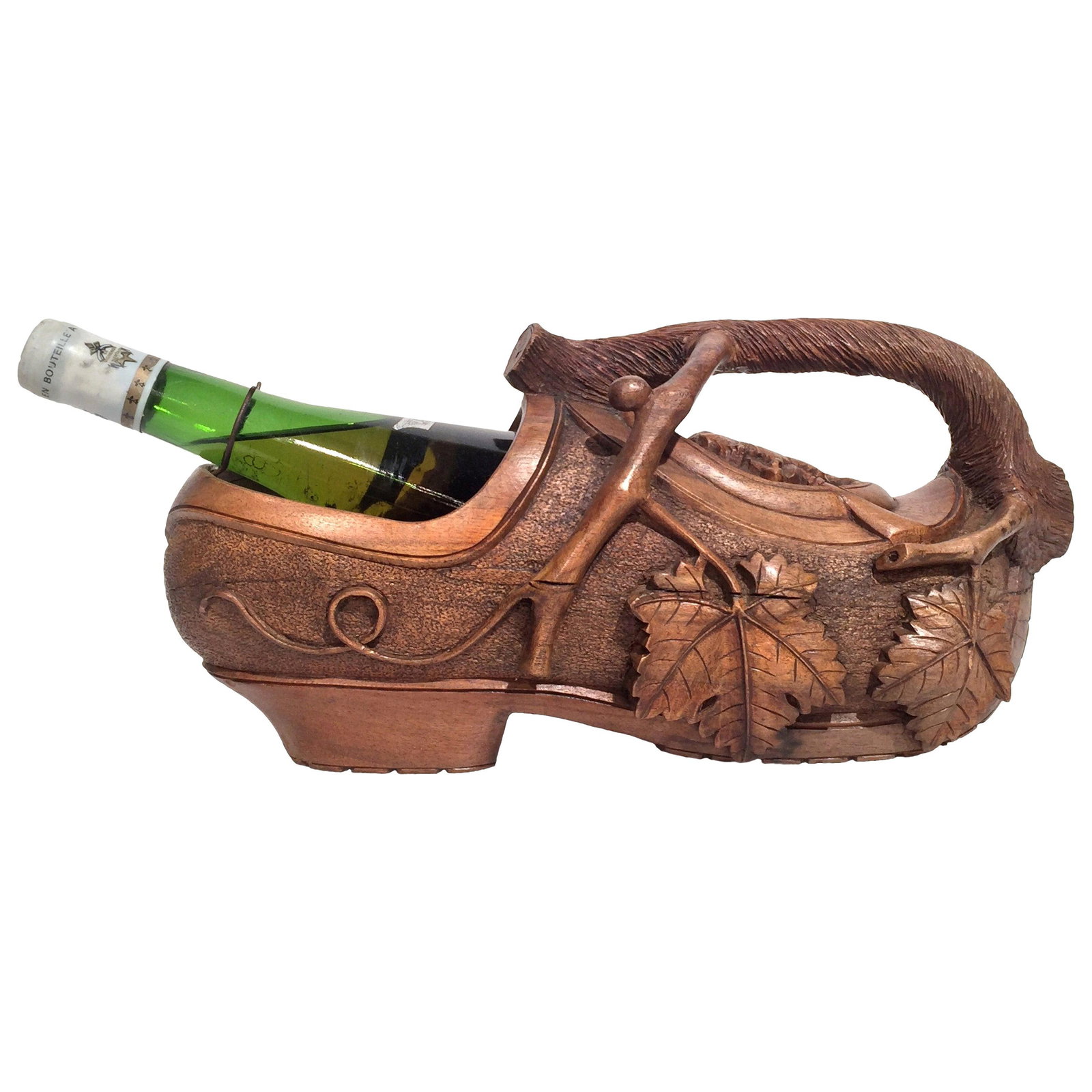 French Black Forest Walnut Clog-Shaped Wine Bottle Holder: French Black Forest Walnut Clog-Shaped Wine Bottle Holder This early 20th century French wine holder is expertly hand-carved from walnut in the form of a traditional sabot (wooden clog), reflecting th
