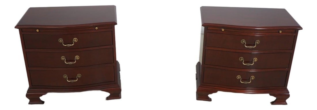 Set of Two Mahogany Chippendale Three Drawer Bedside Tables: Set of Two Mahogany Chippendale Three Drawer Bedside Tables This pair of Baker nightstands features a classic Chippendale-inspired design with serpentine curved fronts. Crafted from high-quality reddi