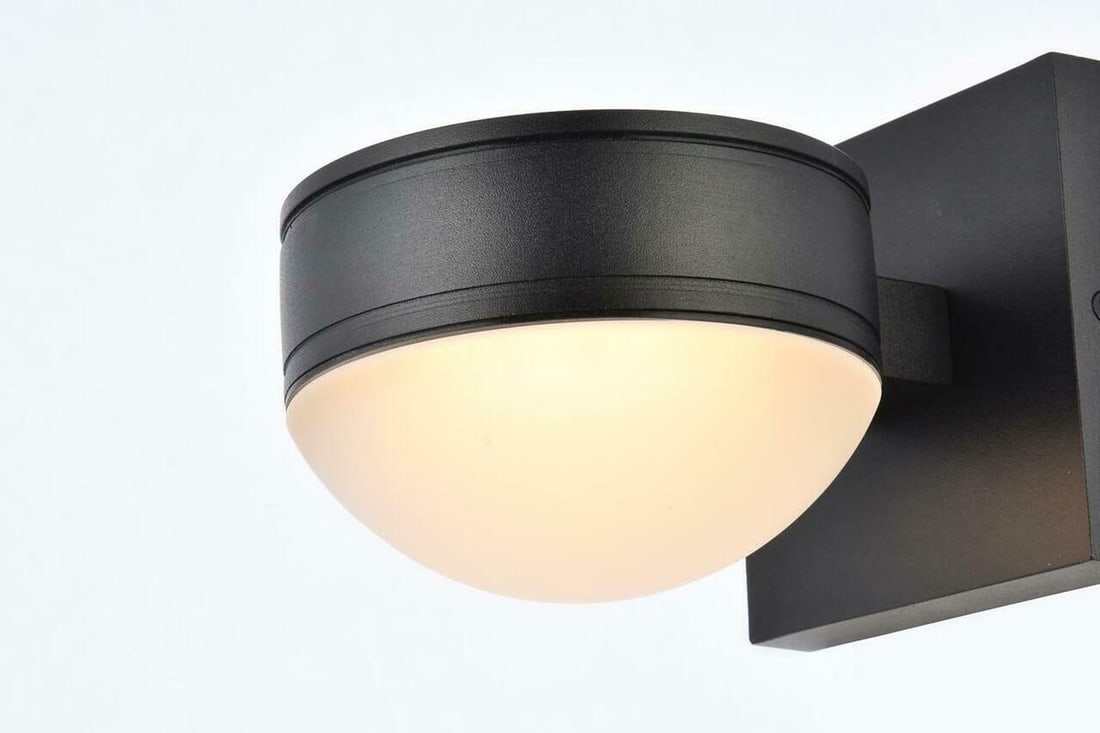 Living District Raine black outdoor LED wall light 5 x 5: Living District Raine black outdoor LED wall light 5 x 5 Modern outdoor wall sconce with a black finish, designed for patio, porch, walkway, yard, and exterior wall installation. It features integrate