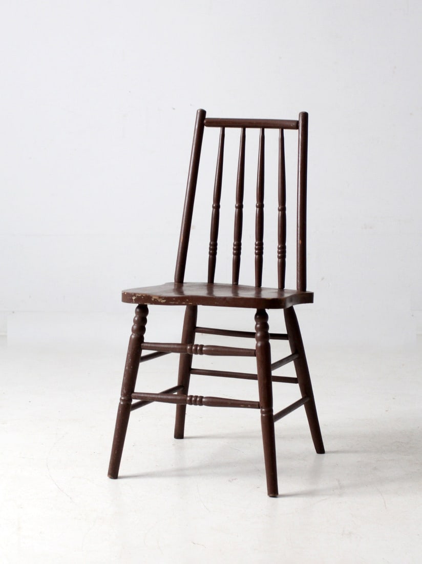 Early 20th Century Antique Spindle Chair Rustic Design: Early 20th Century Antique Spindle Chair Rustic Design This early 20th century antique farmhouse spindle chair features a narrow spindle back and a shaped seat with turned stretchers. Its deep brown p