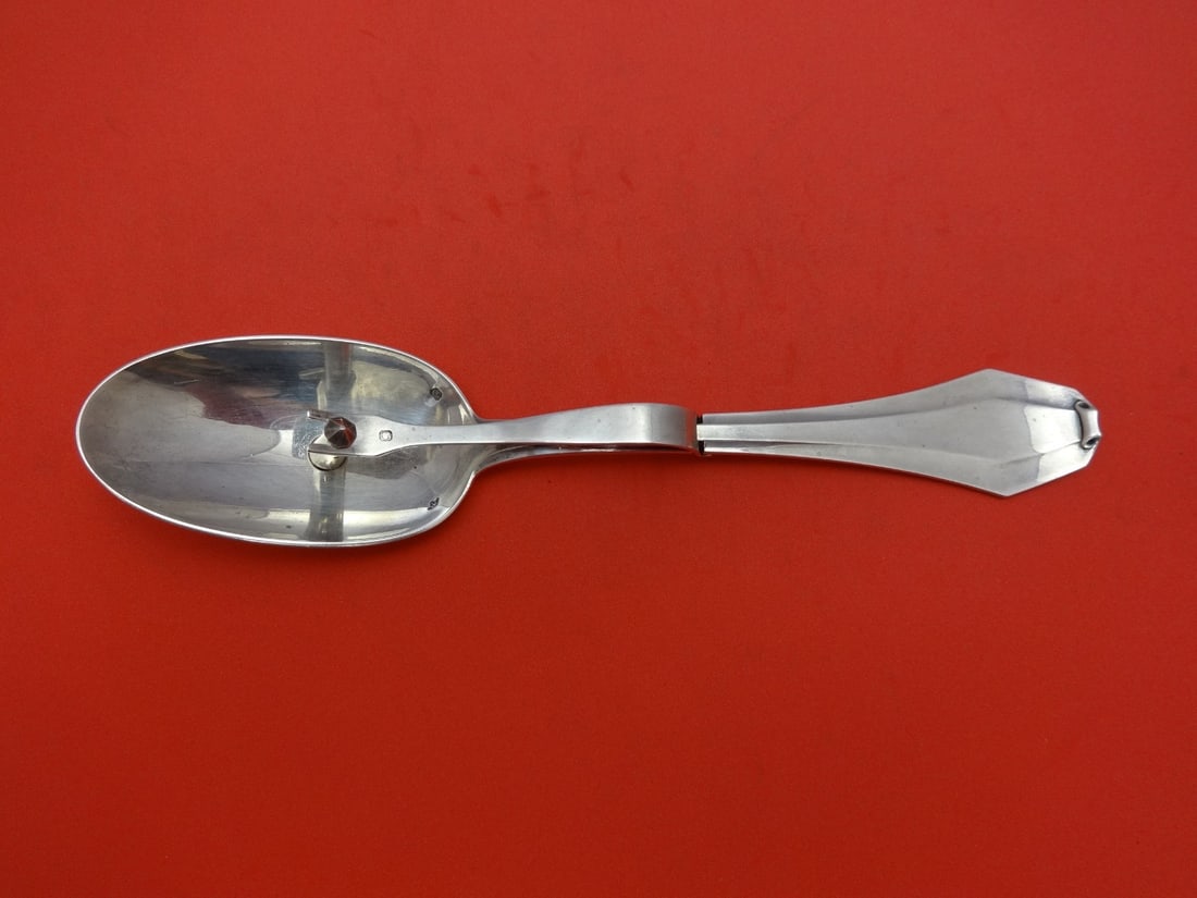 8.25 Inch French Sterling Silver Mechanical Sauce Spoon by Puiforcat: 8.25 Inch French Sterling Silver Mechanical Sauce Spoon by Puiforcat This Puiforcat French sterling silver sauce spoon features a mechanical design with a hole in the bowl, allowing sauce to pass thro