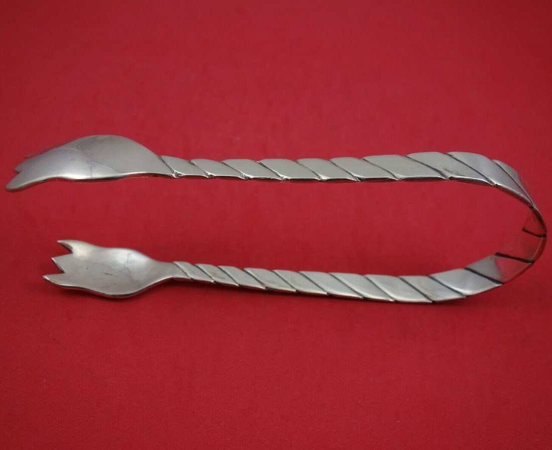 Sanborns Sterling Silver Handwrought Horseshoe Ice Tong 7 3/4": Sanborns Sterling Silver Handwrought Horseshoe Ice Tong 7 3/4" This exquisite ice tong from Sanborns showcases a handwrought design in a unique horseshoe shape. Measuring 7 3/4 inches, it is crafted f