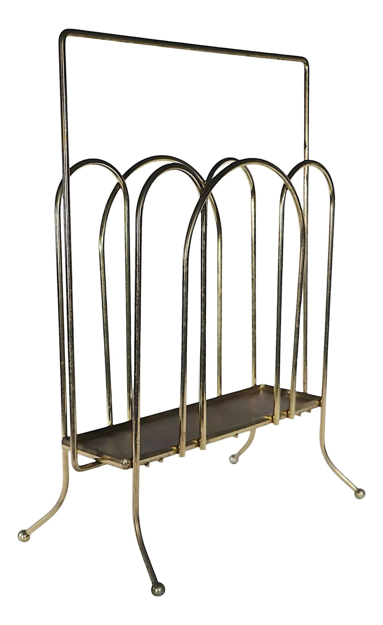 Stylish Mid Century Brass Plated Magazine Rack 1950s: Stylish Mid Century Brass Plated Magazine Rack 1950s This chic mid-century magazine rack, dating back to the 1950s and 1960s, features elegantly designed brass-plated iron rods complemented by a faux 