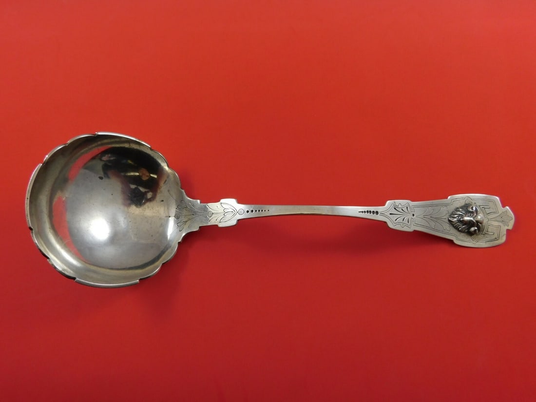 Schohay & Ludwig Ram Coin Silver Oyster Ladle 11 1/4 Inch 3D Design: Schohay & Ludwig Ram Coin Silver Oyster Ladle 11 1/4 Inch 3D Design This exquisite coin silver oyster ladle, crafted by Schohay & Ludwig, features a unique scalloped bowl design and a striking 3D appl