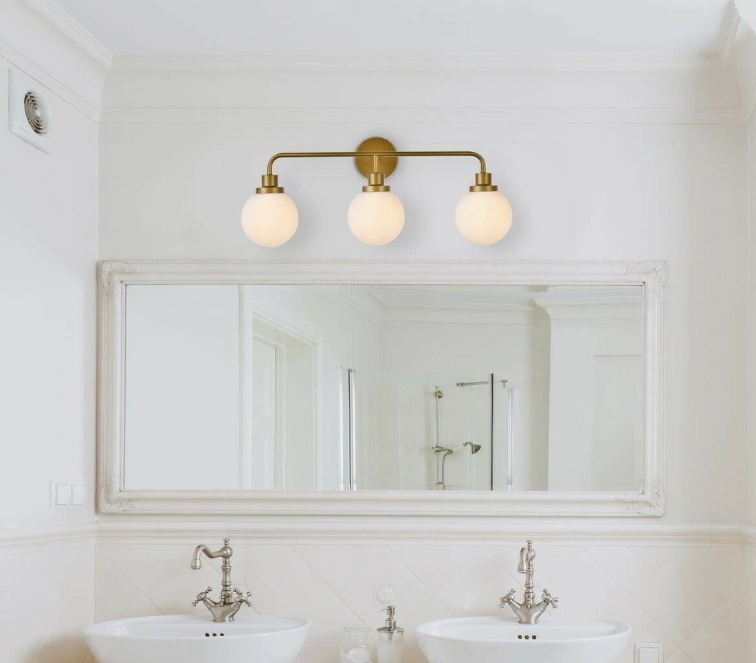 Hanson 3 Light Brass Wall Sconce with Frosted Glass Shades: Hanson 3 Light Brass Wall Sconce with Frosted Glass Shades This modern wall sconce features a brass-finished metal frame and frosted glass shades, offering both upward and downward lighting. Designed 