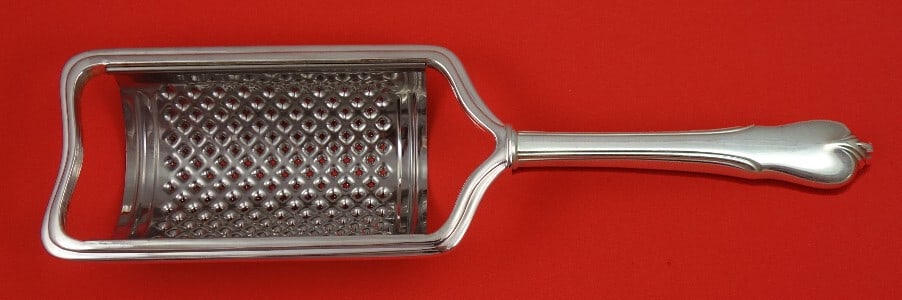 Wallace Grand Colonial Sterling Silver Custom Cheese Grater 8.5": Wallace Grand Colonial Sterling Silver Custom Cheese Grater 8.5" This exquisite cheese grater is crafted by Wallace in the elegant Grand Colonial pattern. Made from sterling silver, it features a holl