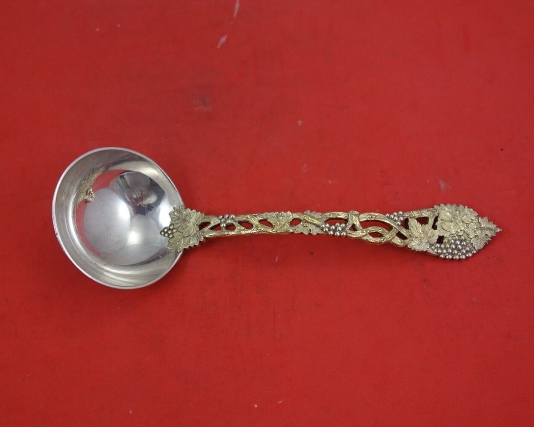 CJ Vander Sterling Silver Gravy Ladle Vermeil Chased Pierced Vine 6 3/8": CJ Vander Sterling Silver Gravy Ladle Vermeil Chased Pierced Vine 6 3/8" This exquisite gravy ladle by CJ Vander showcases a beautiful Chased and Pierced Vine pattern. Crafted from sterling silver and