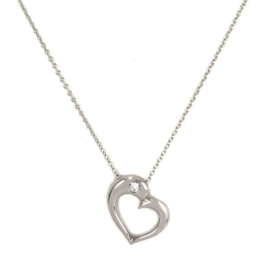 Hearts On Fire 18k White Gold Necklace with Diamond Heart Pendant: Hearts On Fire 18k White Gold Necklace with Diamond Heart Pendant Hearts On Fire pendant necklace in 18k white gold, featuring a sculptural open heart design accented with one natural diamond. This or