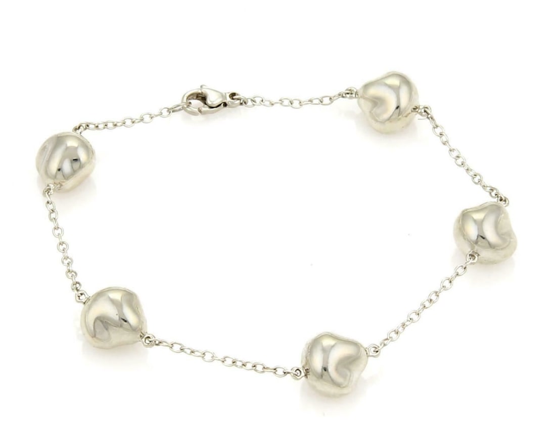 Sterling Silver Nugget Charm Bracelet Tiffany Co Elsa Peretti 5 Charms: Sterling Silver Nugget Charm Bracelet Tiffany Co Elsa Peretti 5 Charms Pre-owned Tiffany & Co. Elsa Peretti 5 Nugget charm bracelet in sterling silver. This original bracelet features five sculptural 