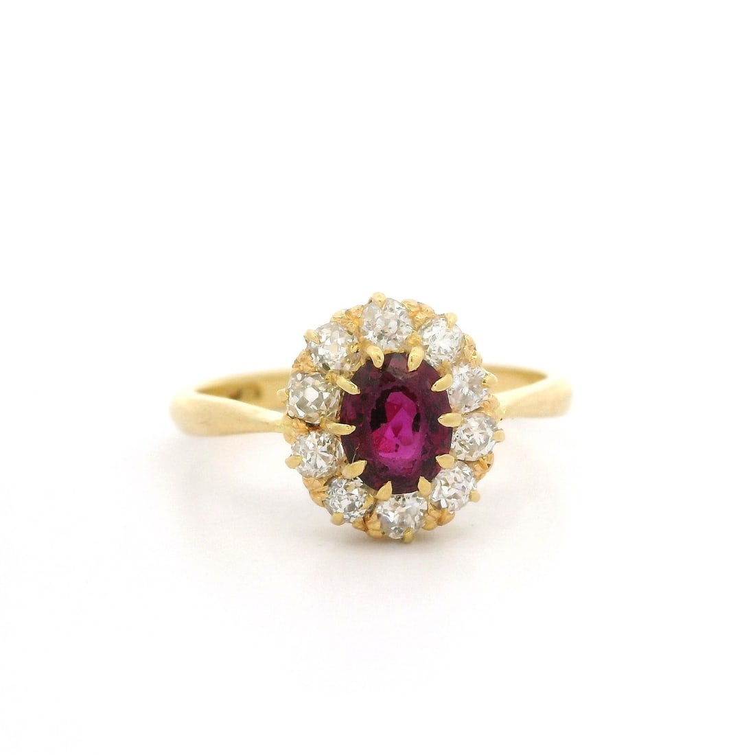 Antique Victorian 1.25ct Ruby Diamond Halo Cluster Ring in Yellow Gold: Antique Victorian 1.25ct Ruby Diamond Halo Cluster Ring in Yellow Gold This exquisite Antique Victorian cocktail ring features a stunning 1.25ctw oval ruby at its center, elegantly surrounded by a hal