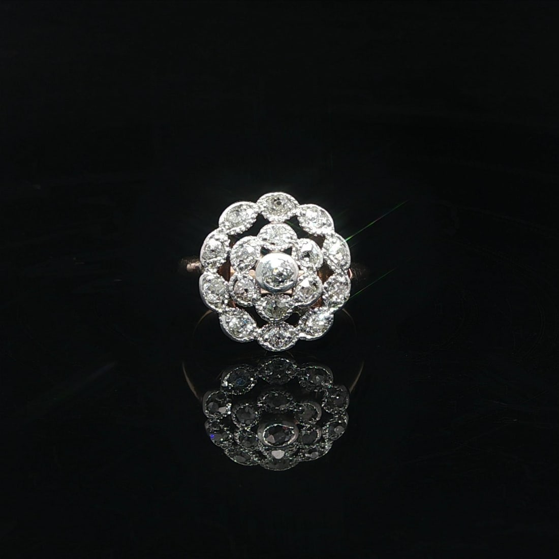 Edwardian Era Diamond Cluster Ring in Yellow Gold and Platinum with Old Mine Cuts: Edwardian Era Diamond Cluster Ring in Yellow Gold and Platinum with Old Mine Cuts This antique Edwardian cocktail ring features a round cluster design set with approximately 0.50 carats total weight o