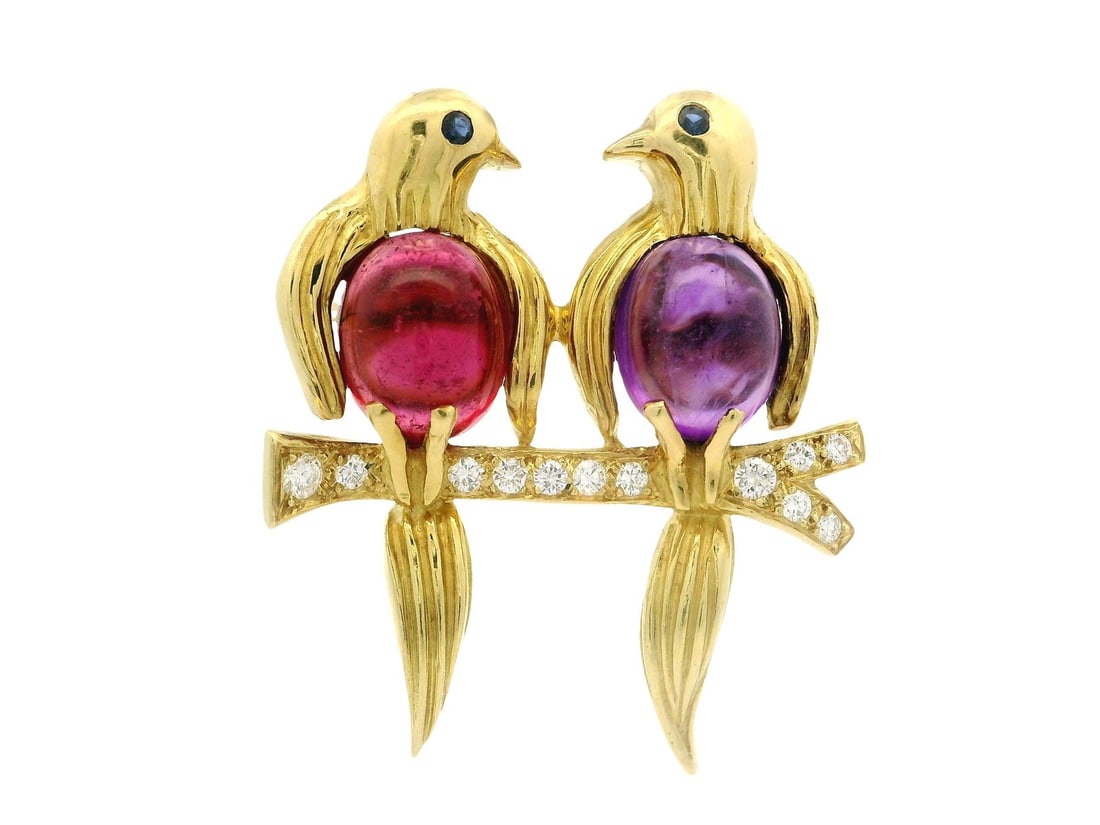 18k Gold Twin Birds Brooch with Amethyst Tourmaline and Diamonds: 18k Gold Twin Birds Brooch with Amethyst Tourmaline and Diamonds This exquisite brooch features a charming design of twin birds perched on a branch, crafted in solid 18k yellow gold. The piece is ador