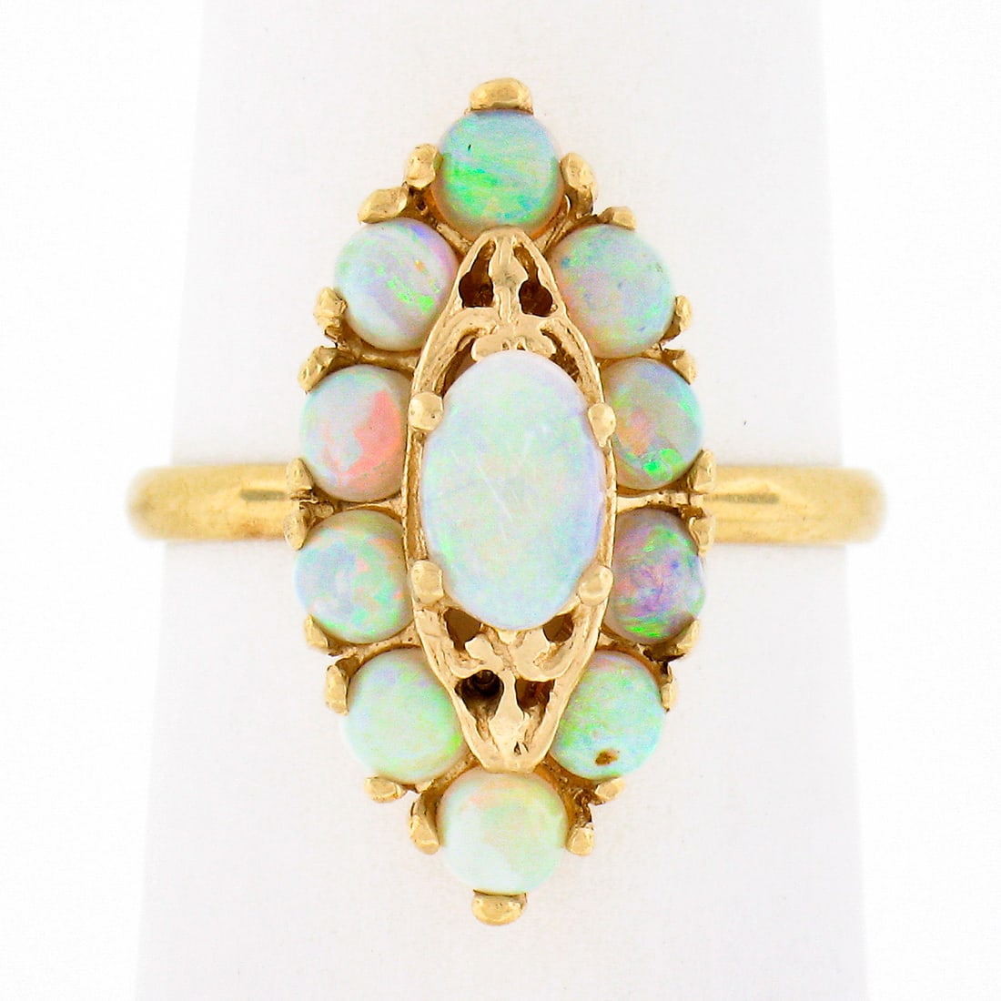 Retro 14K Yellow Gold Opal Halo Ring Navette Form Size 5.5: Retro 14K Yellow Gold Opal Halo Ring Navette Form Size 5.5 Vintage navette-shaped ring crafted in solid 14k yellow gold, featuring a natural oval cabochon Australian opal at the center with a halo of 