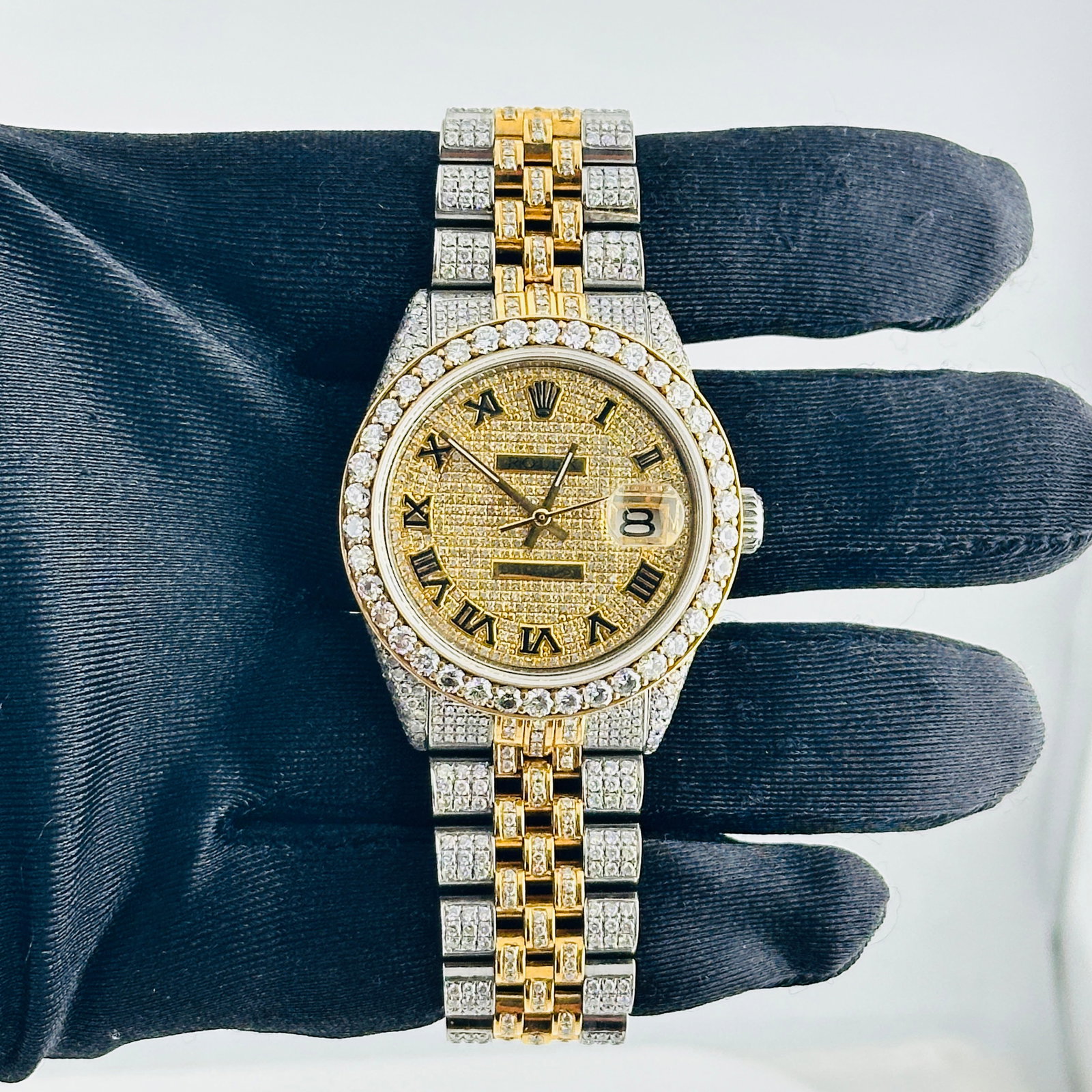 Rolex Datejust 18k Aftermarket Jubilee Bracelet Ref 1603 Roman Dial: Rolex Datejust 18k Aftermarket Jubilee Bracelet Ref 1603 Roman Dial This men's Rolex Datejust features an Iced Out Roman dial, complemented by a pave diamond bezel and an aftermarket Jubilee bracelet 