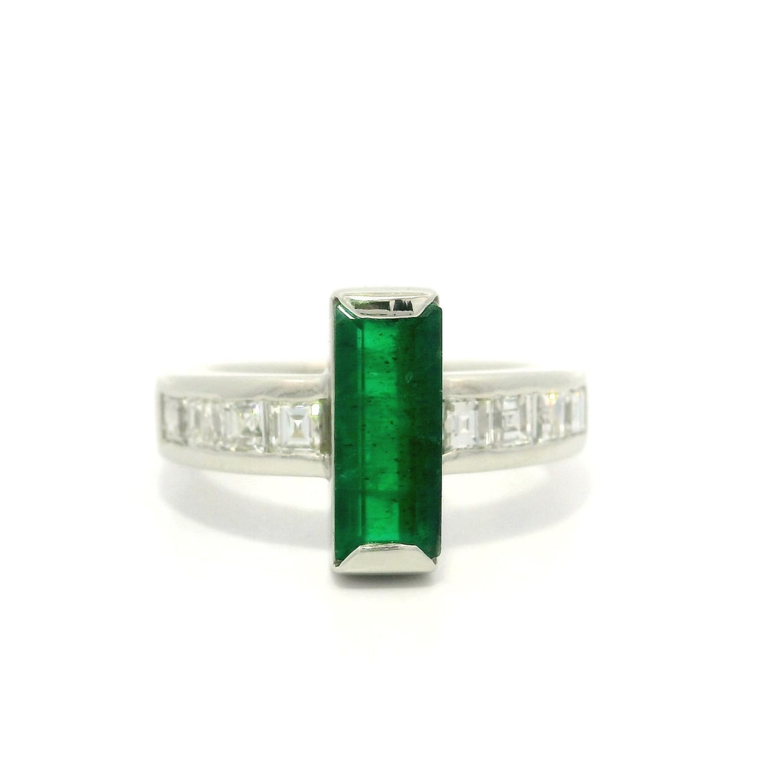 Platinum 1.80ct Emerald and Carre Cut Diamond Cocktail Ring: Platinum 1.80ct Emerald and Carre Cut Diamond Cocktail Ring This exquisite cocktail ring features a stunning long rectangular natural emerald, elegantly prong set in solid platinum. The vibrant green 