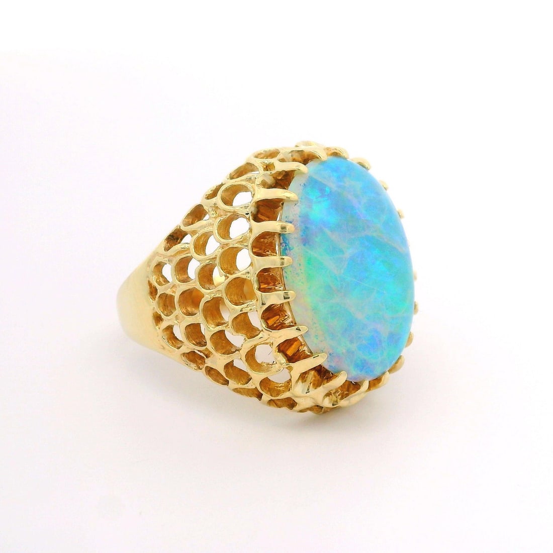 14k Yellow Gold Fiery Oval Opal Dome Cocktail Ring: 14k Yellow Gold Fiery Oval Opal Dome Cocktail Ring This stunning cocktail ring features a dome design crafted from solid 14k yellow gold, showcasing a fiery oval opal at its center. The opal is a natu