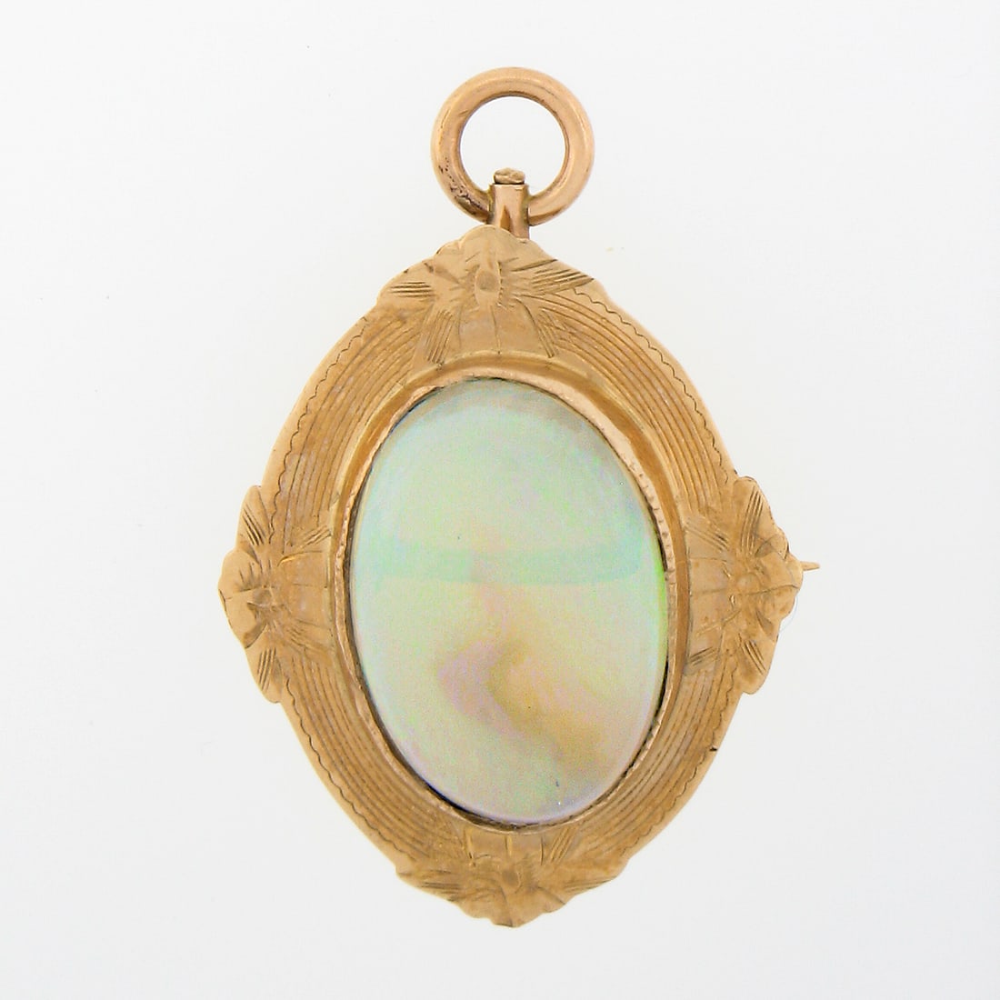 10K Rosy Yellow Gold Opal Convertible Brooch Pendant: 10K Rosy Yellow Gold Opal Convertible Brooch Pendant This antique brooch and pendant is crafted from solid 10K rosy yellow gold and features a hand-engraved floral frame. At its center is an oval cabo
