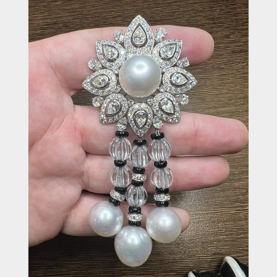 Diamond and South Sea Pearl Brooch in 18K White Gold by ELLAGEM: Diamond and South Sea Pearl Brooch in 18K White Gold by ELLAGEM This stunning brooch features a luxurious design crafted from 18K white gold, showcasing an exquisite arrangement of diamonds and South 