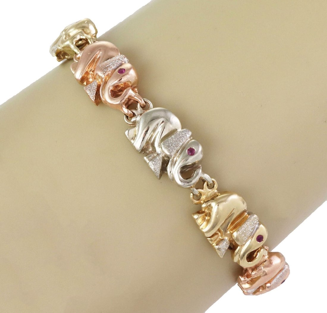 Vintage Unbranded Elephant Link Bracelet Tri Color Gold Ruby 7.5": Vintage Unbranded Elephant Link Bracelet Tri Color Gold Ruby 7.5" Vintage estate link bracelet featuring sculpted elephant motifs with ruby accents. Crafted in tri-color gold, this articulated bracele