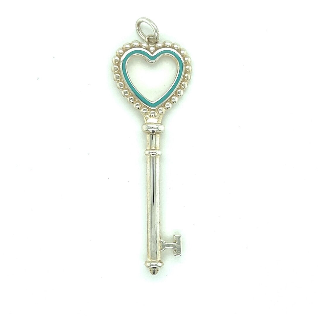 Tiffany & Co. Heart Key Charm Pendant in Sterling Silver Blue Enamel: Tiffany & Co. Heart Key Charm Pendant in Sterling Silver Blue Enamel Pre-owned Tiffany & Co. Heart Key charm pendant crafted in sterling silver with blue enamel accents. This signed pendant features a