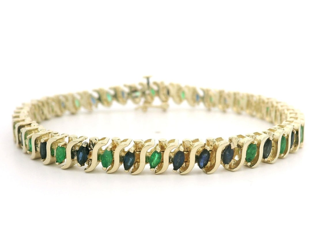 14k Yellow Gold 3ctw Marquise Emerald Sapphire Bracelet: 14k Yellow Gold 3ctw Marquise Emerald Sapphire Bracelet This exquisite bracelet is crafted from solid 14k yellow gold, featuring a stunning combination of marquise-cut natural emeralds and sapphires. 