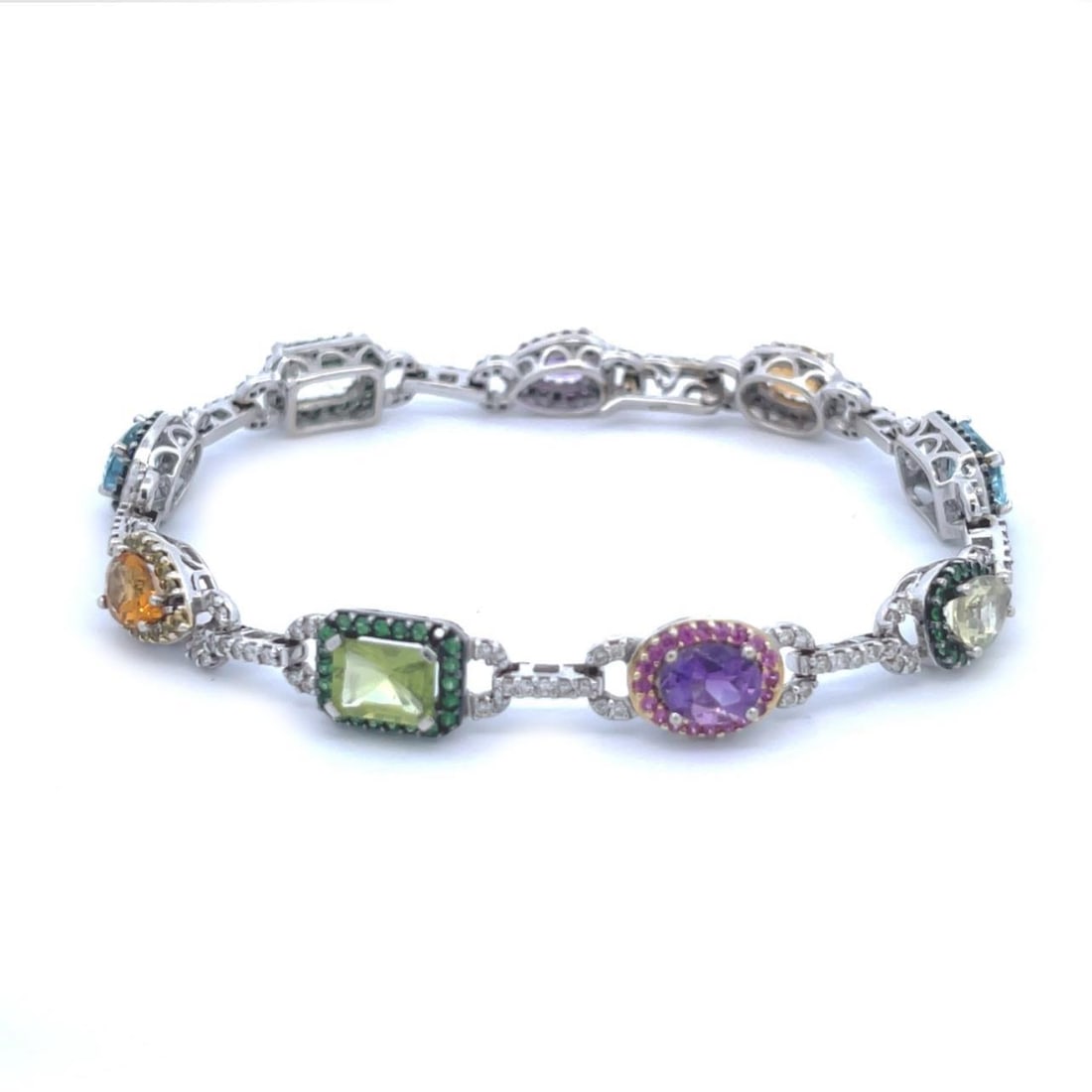 Colorful 18k White Gold Bracelet with Diamonds and Gemstones: Colorful 18k White Gold Bracelet with Diamonds and Gemstones This exquisite bracelet is crafted from 18k white gold and adorned with 9 assorted gemstones in vibrant colors including citrine, blue topa