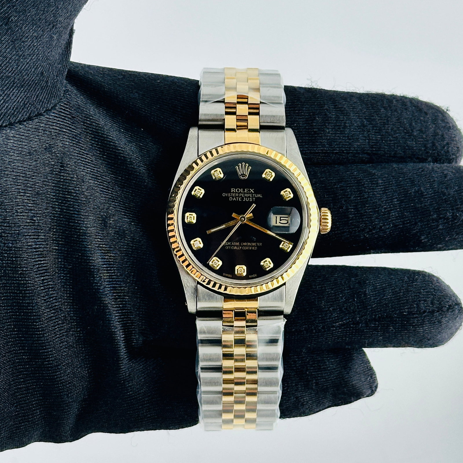 Rolex Datejust 16013 Black Diamond Dial Fluted Bezel Aftermarket Jubilee Bracelet: Rolex Datejust 16013 Black Diamond Dial Fluted Bezel Aftermarket Jubilee Bracelet This Rolex Datejust features a black diamond dial and a fluted bezel, complemented by an aftermarket Jubilee bracelet.