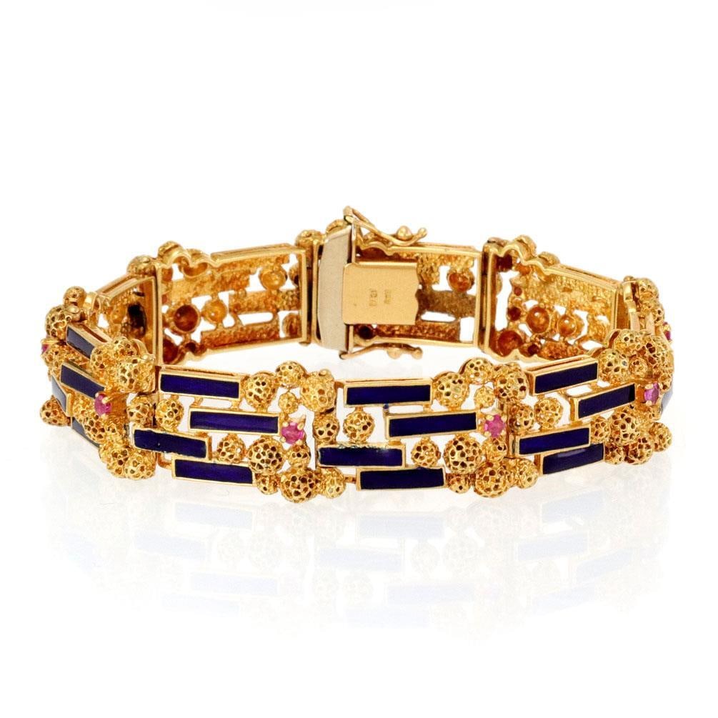 Vintage 18k Yellow Gold Ruby Enamel Bracelet 15mm Wide: Vintage 18k Yellow Gold Ruby Enamel Bracelet 15mm Wide This exquisite vintage bracelet features a stunning combination of ruby gemstones and vibrant blue enamel, beautifully crafted from 18k yellow go