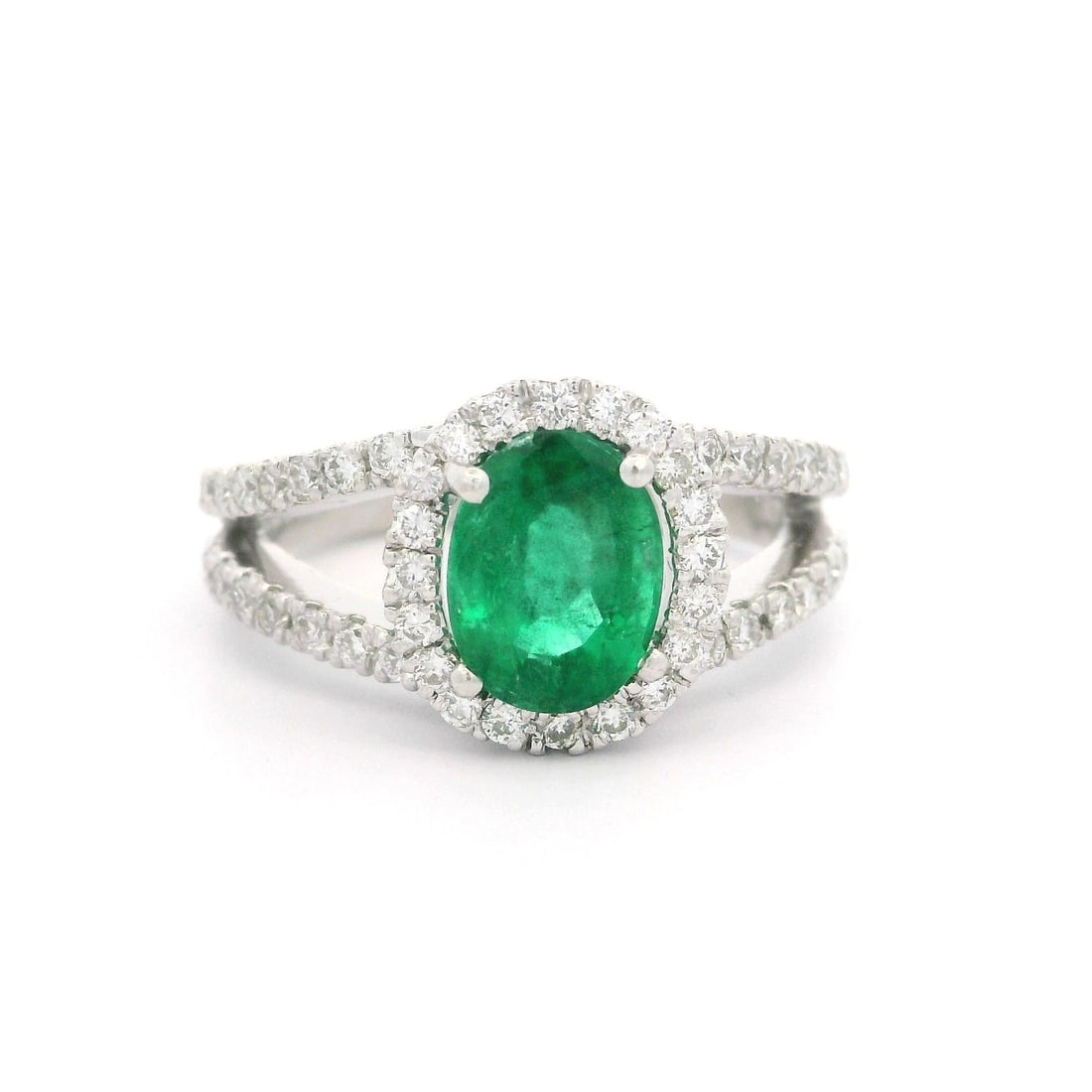 18k White Gold 1.81ct Oval Emerald Diamond Split Shank Ring: 18k White Gold 1.81ct Oval Emerald Diamond Split Shank Ring This exquisite ring features a stunning natural oval emerald, prong set in solid 18k white gold. The emerald measures approximately 8x6mm an