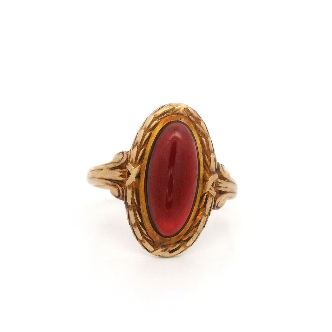 Antique Victorian 14k Gold Garnet Floral Halo Ring: Antique Victorian 14k Gold Garnet Floral Halo Ring This exquisite Antique Victorian ring features a stunning elongated oval garnet at its center, showcasing a deep red color in a cabochon cut. The gar