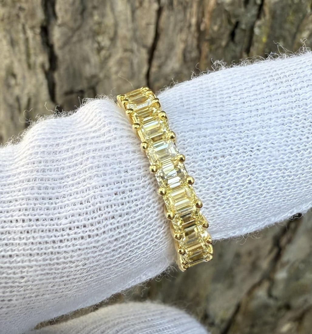 18k Yellow Gold Eternity Band with 27 Fancy Yellow Emerald Cut Diamonds Size 6: 18k Yellow Gold Eternity Band with 27 Fancy Yellow Emerald Cut Diamonds Size 6 This elegant eternity band ring features approximately 4.50 carats of natural, fancy light yellow emerald-cut diamonds, p