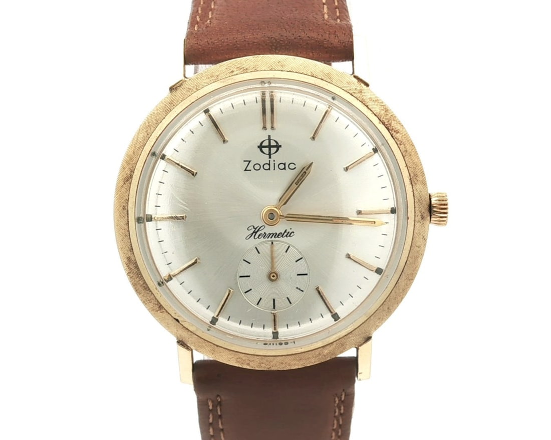 Vintage Zodiac Hermetic 14k Yellow Gold Mechanical Watch 33mm: Vintage Zodiac Hermetic 14k Yellow Gold Mechanical Watch 33mm This vintage unisex wristwatch from Zodiac features a stunning 33mm case made of solid 14k yellow gold. The watch showcases a sleek gray d