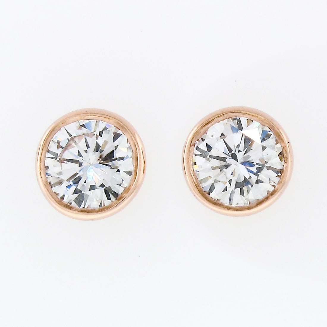 14k Rose Gold Diamond Stud Earrings 0.42ctw Round Bezel Set Pair: 14k Rose Gold Diamond Stud Earrings 0.42ctw Round Bezel Set Pair A pair of un-used diamond stud earrings crafted in solid 14k rose gold. Each earring features a natural round brilliant cut diamond in 