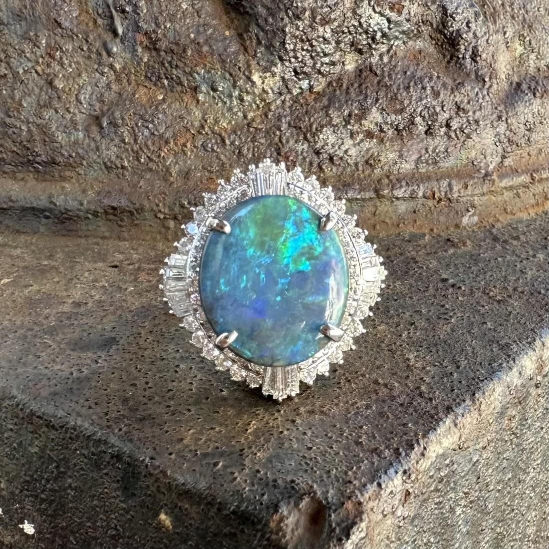 GIA Platinum Black Opal Diamond Cocktail Ring Size 7.5: GIA Platinum Black Opal Diamond Cocktail Ring Size 7.5 This platinum cocktail ring features a large natural black opal as its centerpiece, expertly cut in an oval cabochon shape and weighing 5.22 cara