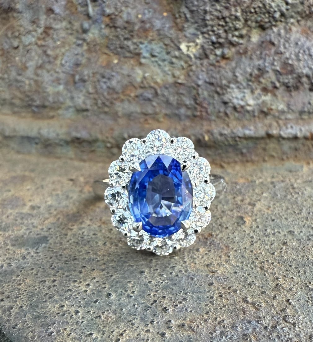 GIA Platinum Cocktail Ring Ceylon Sapphire Halo 4.34ctw Size 6.5: GIA Platinum Cocktail Ring Ceylon Sapphire Halo 4.34ctw Size 6.5 This classic platinum cocktail ring features a GIA-certified, no-heat Ceylon sapphire as its centerpiece. The oval brilliant cut sapphi