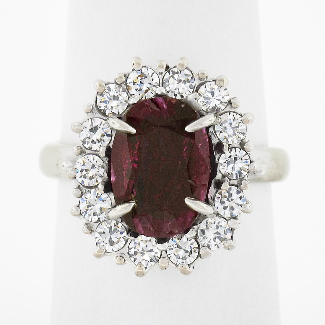 18k White Gold Cocktail Ring with GIA No Heat Ruby and Diamond Halo: 18k White Gold Cocktail Ring with GIA No Heat Ruby and Diamond Halo Vintage cocktail ring featuring a natural ruby center stone surrounded by a diamond halo cluster. The center ruby is GIA certified a